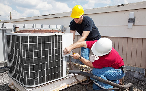 HVAC Technicians repairing an AC