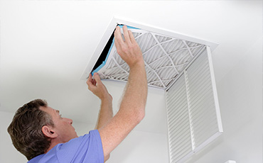 Person changing an air filter